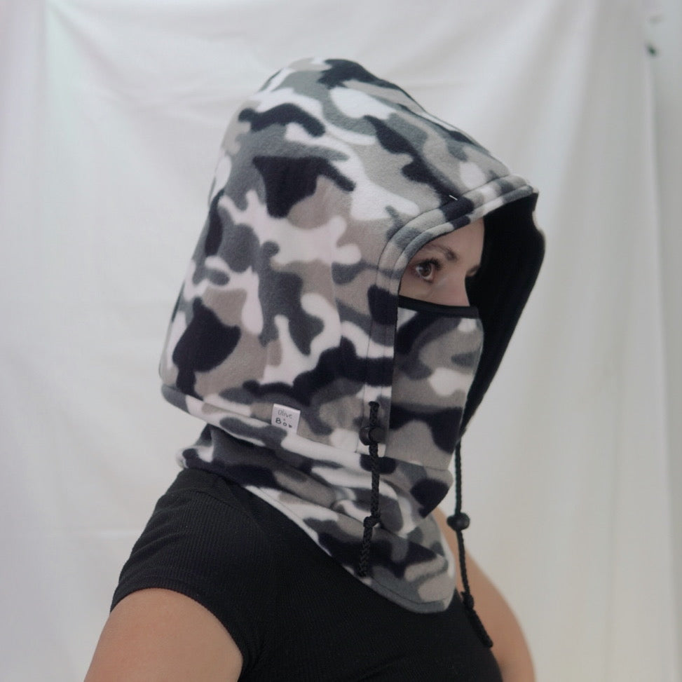 A handmade Tundra Camo Hoodeanie, featuring a cozy hood and a relaxed fit in a stylish camouflage print. The soft, breathable fabric offers ultimate comfort, making it perfect for layering or wearing on its own. Designed for versatility, it can be worn as a hoodie or slouched down as a beanie.