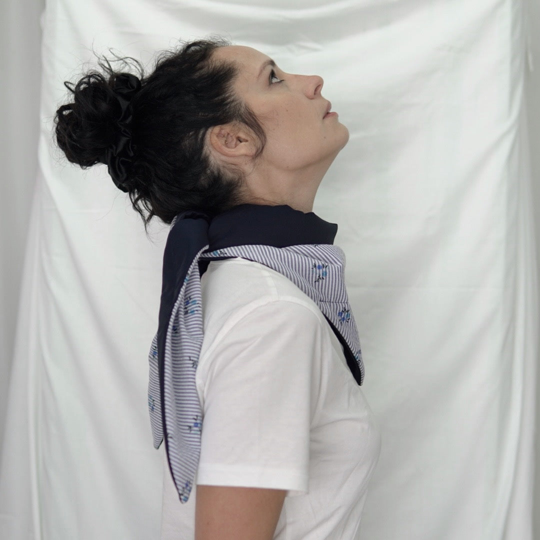 Reversible quilted shawl with a dark floral cotton print and water-resistant black lining, perfect for elegant layering and cool weather style.