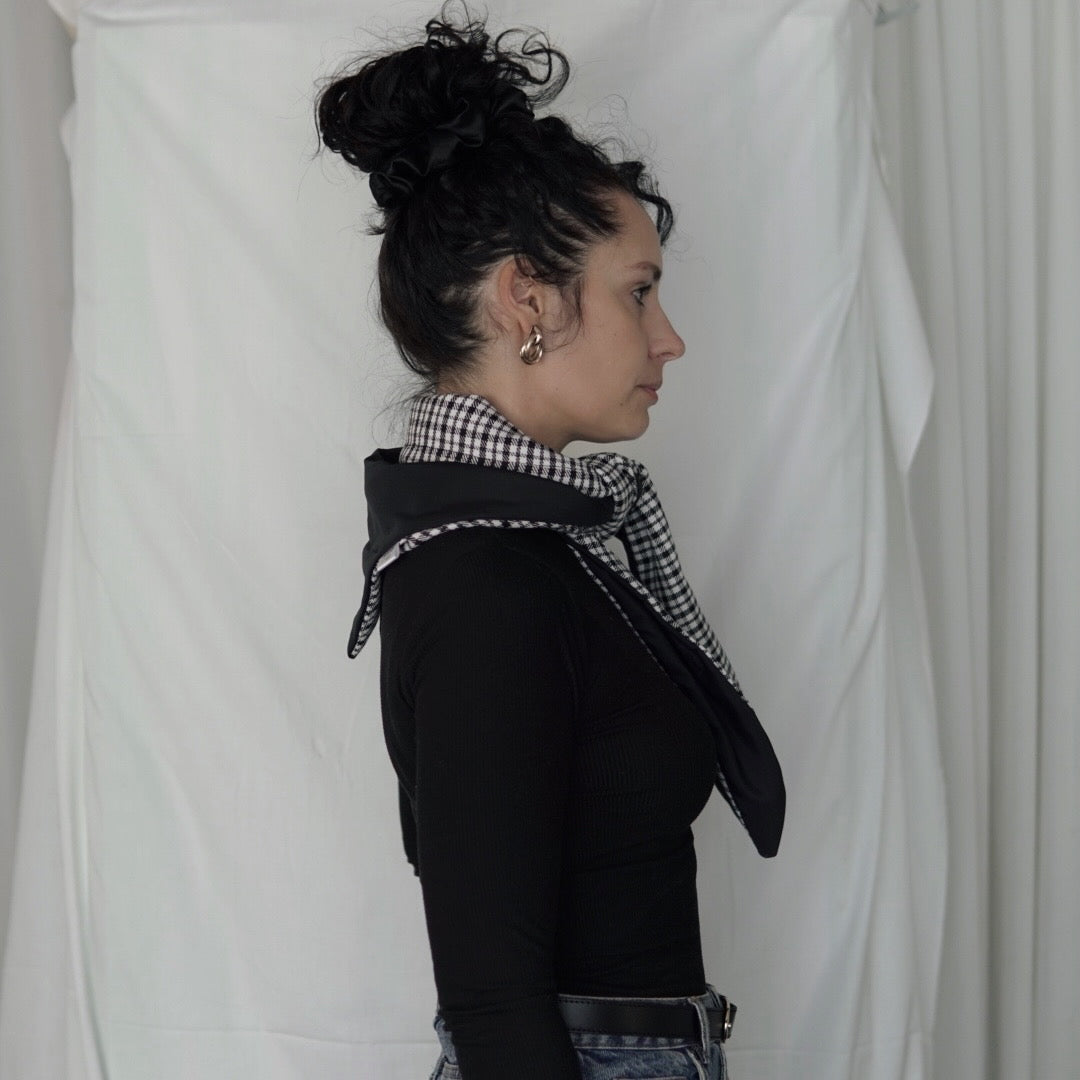 Reversible black and white quilted shawl with water-resistant outer and patterned polyester lining, ideal for stylish, lightweight layering in all seasons.
