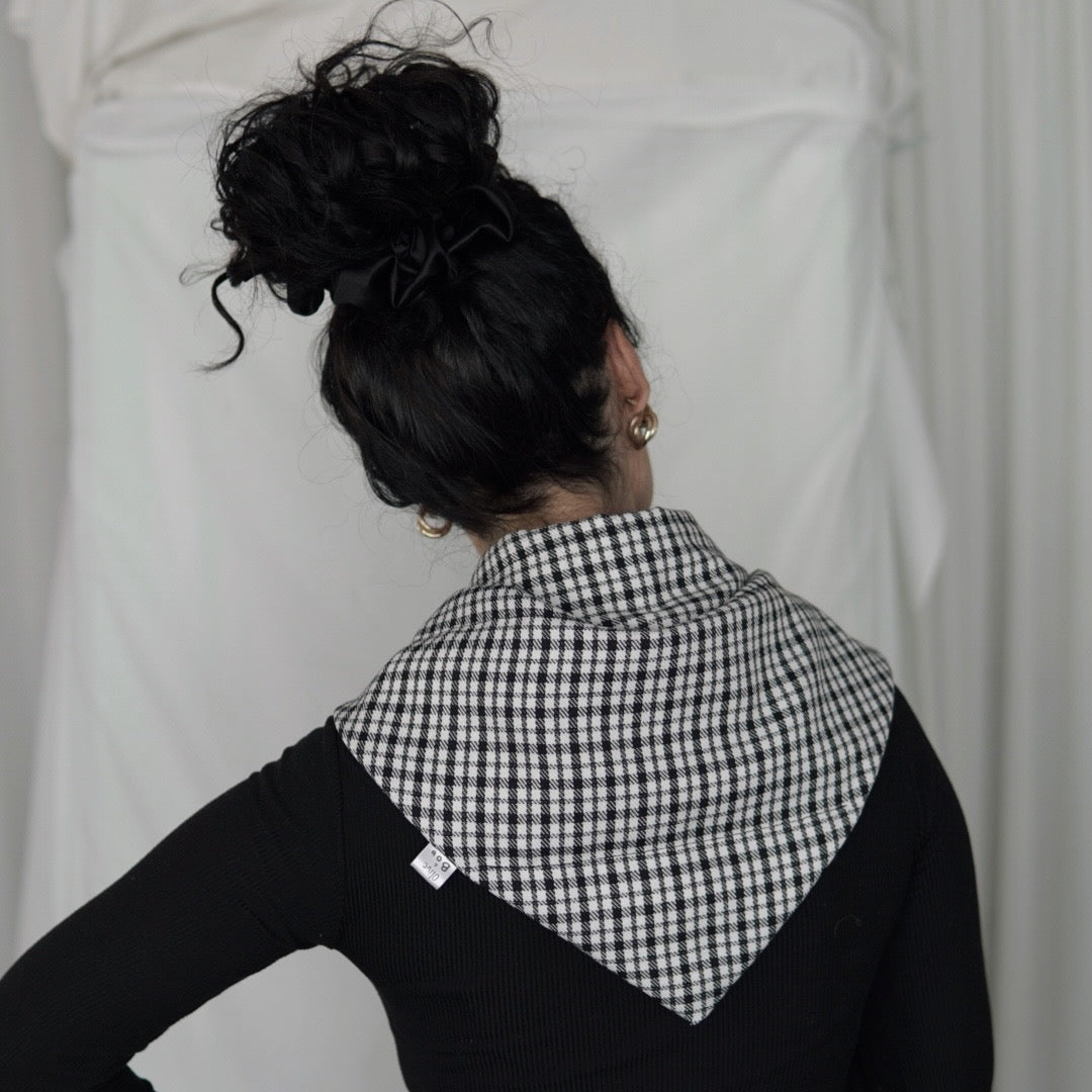 Reversible black and white quilted shawl with water-resistant outer and patterned polyester lining, ideal for stylish, lightweight layering in all seasons.
