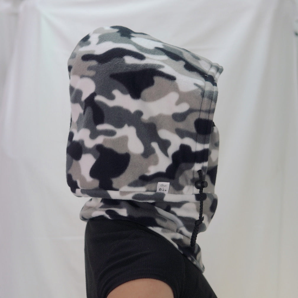 A handmade Tundra Camo Hoodeanie, featuring a cozy hood and a relaxed fit in a stylish camouflage print. The soft, breathable fabric offers ultimate comfort, making it perfect for layering or wearing on its own. Designed for versatility, it can be worn as a hoodie or slouched down as a beanie.