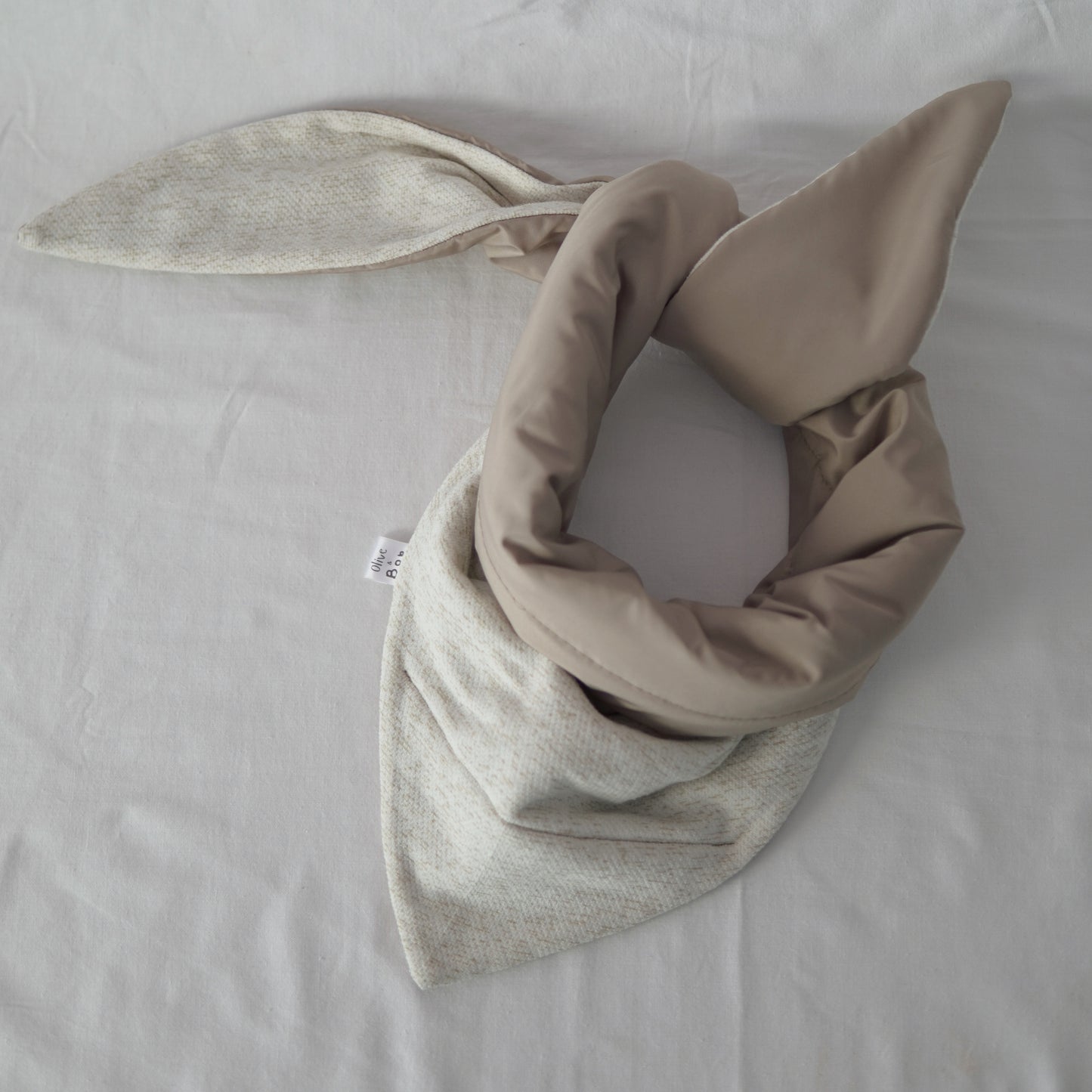 Reversible quilted shawl in soft sand-toned cotton and oat-hued linen, designed for effortless layering with a natural, textured finish.