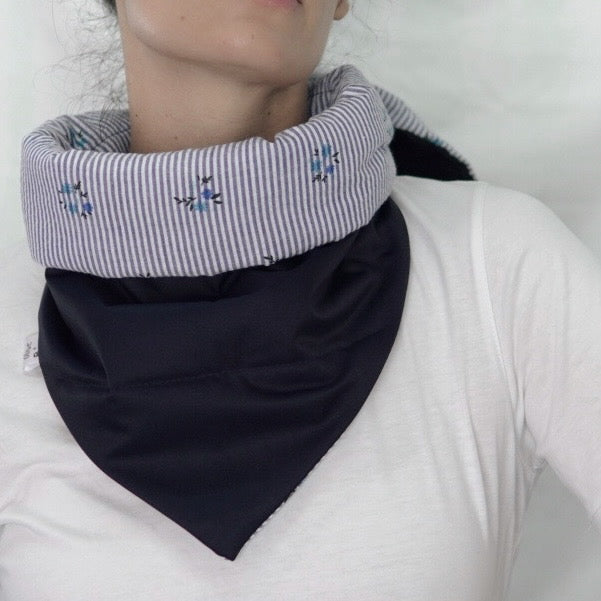 Reversible quilted shawl with a dark floral cotton print and water-resistant black lining, perfect for elegant layering and cool weather style.