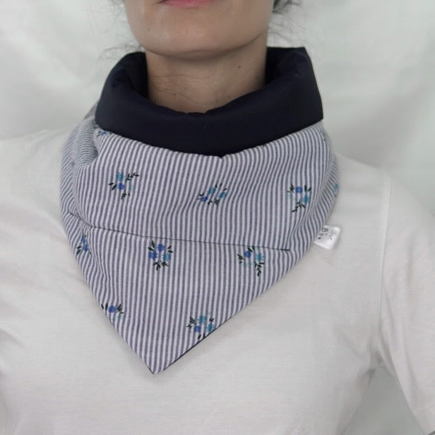 Reversible quilted shawl with a dark floral cotton print and water-resistant black lining, perfect for elegant layering and cool weather style.