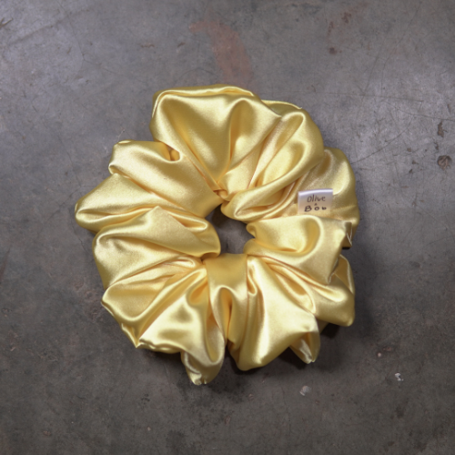 Yellow satin scrunchie in regular size with a silky finish, bright hair accessory for everyday styling.
