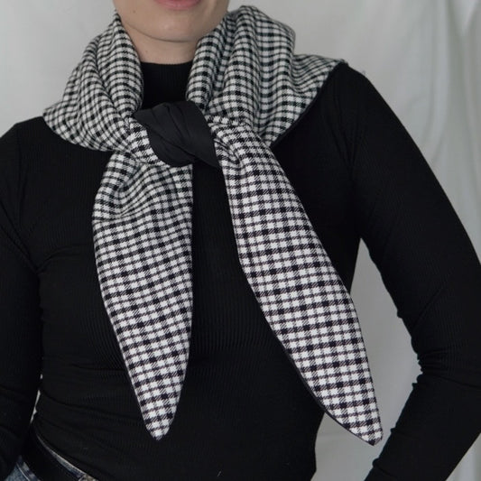 Reversible black and white quilted shawl with water-resistant outer and patterned polyester lining, ideal for stylish, lightweight layering in all seasons.