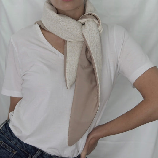 Reversible quilted shawl in soft sand-toned cotton and oat-hued linen, designed for effortless layering with a natural, textured finish.